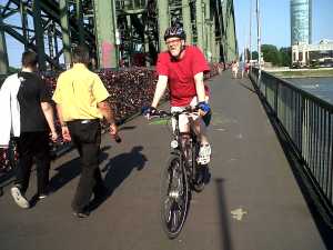 Cyclist on bridge over Rhine Cologne